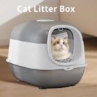 Cat looking out of a gray and white enclosed litter box
