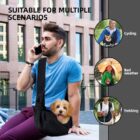 Person carrying a small dog in a black sling outdoors