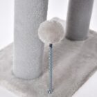 Close-up of spring ball toy beside a gray cat tree post